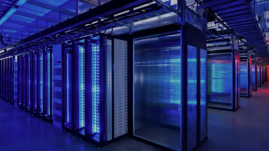 Rows of server racks in a data centre lit in blue